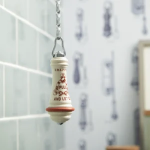 Classic high-level toilet pull with ceramic handle and ornate chain. Designed for traditional bathrooms.